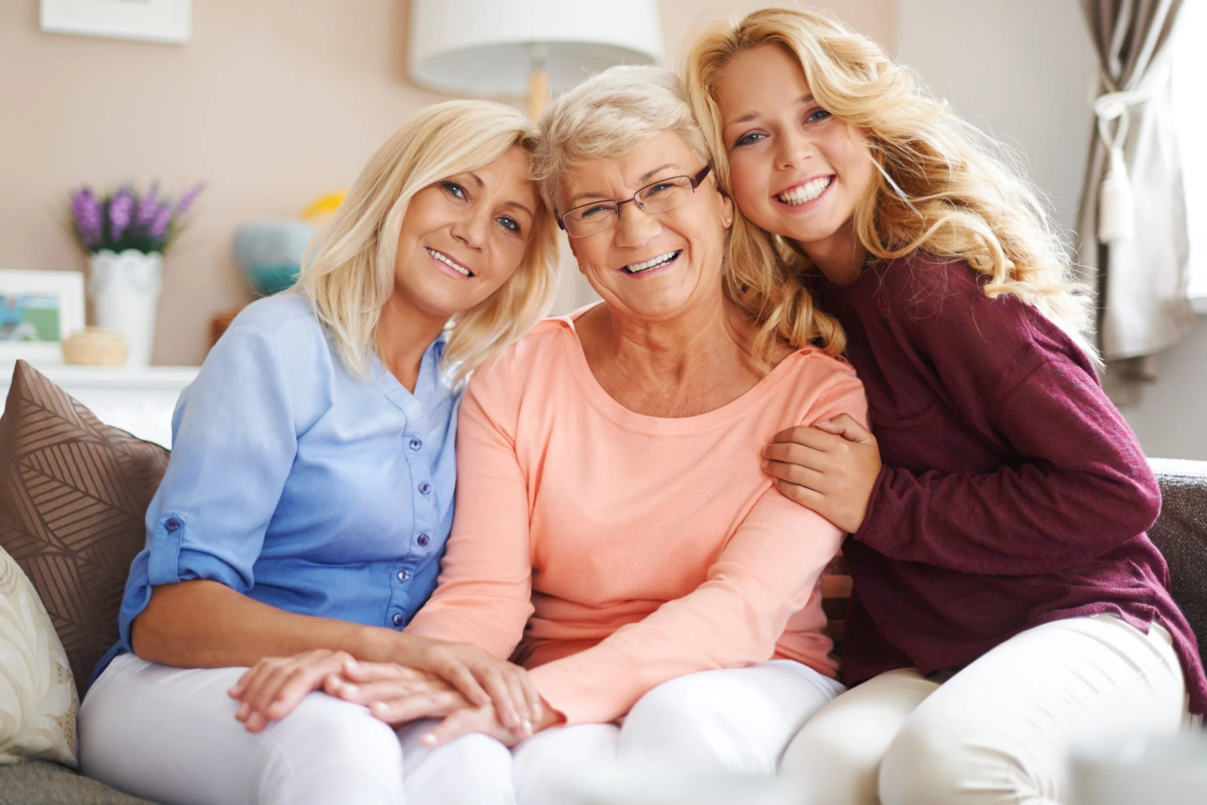 A family gathered closely with their aging loved one, sharing an unhurried moment together.